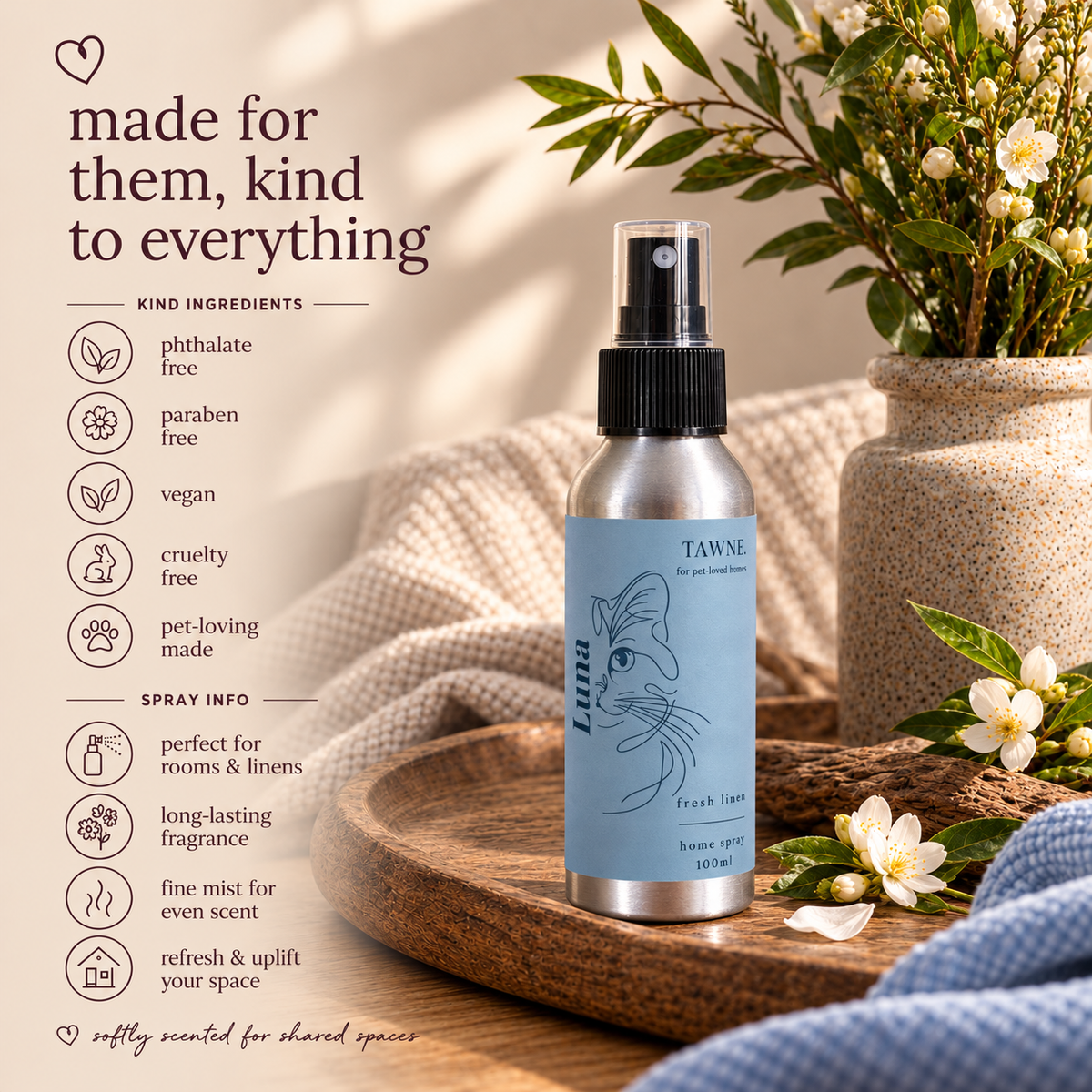A silver spray bottle of Tawne Fresh Scents room spray with a light blue label, styled on a wooden tray with a potted plant and white blossoms in a warm, sunlit setting. Text on the left lists product benefits and ingredients.